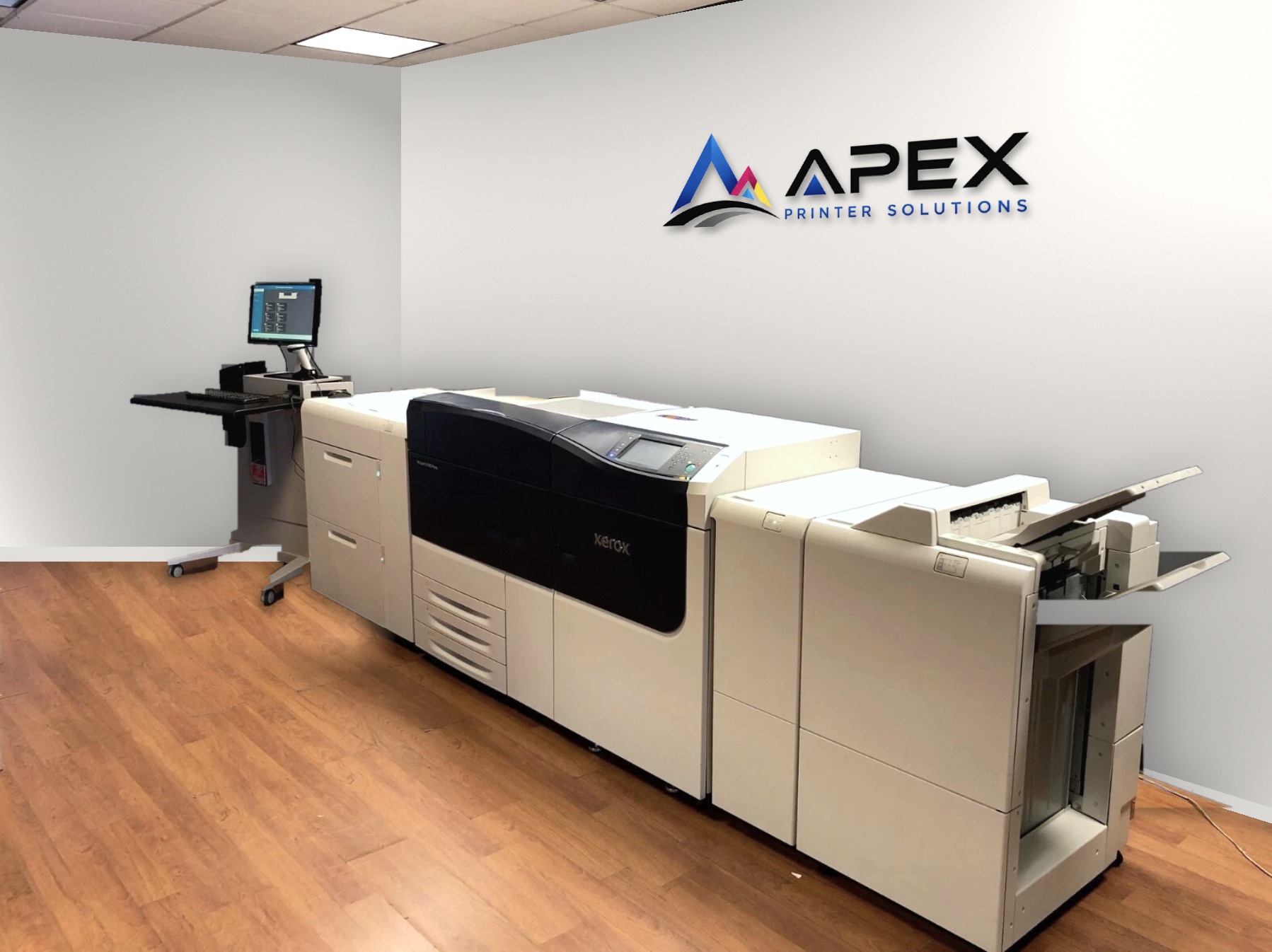 Xerox Versant 4100 Press with its controller workstation below the Apex Printer Solutions sign